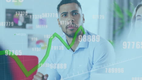 Animation-of-green-line-and-data-processing-over-biracial-businessman-in-office
