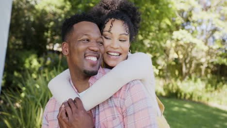 Portrait-of-happy-african-american-couple-embracing-in-garden-at-home,-slow-motion