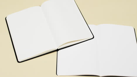 Video-of-books-with-white-blank-pages-and-copy-space-on-yellow-background