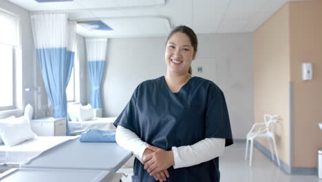 Portrait-of-happy-plus-size-caucasian-female-doctor-in-hospital-ward,-copy-space,-slow-motion