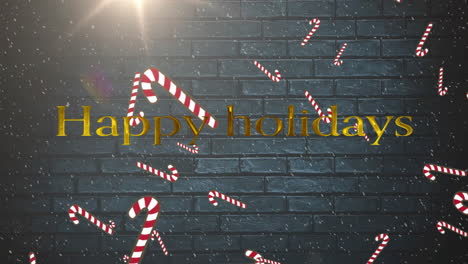 Animation-of-falling-candy-canes,-happy-holidays-text,-lens-flares,-snowfall-over-gray-brick-wall