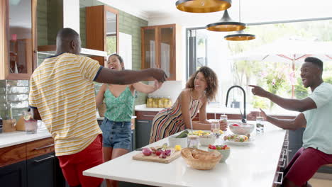 Diverse-group-enjoys-a-dance-in-a-bright-kitchen