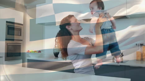 Animation-of-greek-flag-over-caucasian-mother-playing-with-child-in-kitchen