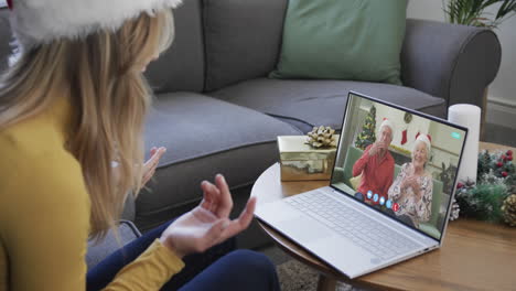 Senior-caucasian-parents-and-adult-daughter-having-christmas-laptop-video-call,-slow-motion