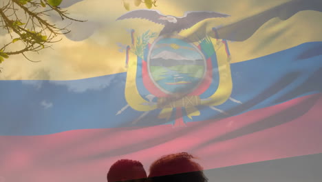 Animation-of-ecuadorian-flag-over-diverse-couple-kissing,-sitting-on-sunny-beach
