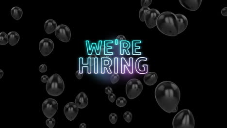 Animation-of-neon-we're-hiring-text-over-black-balloons-on-black-background