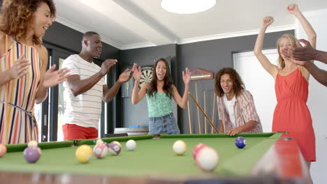 Diverse-friends-enjoy-a-game-of-pool-at-home