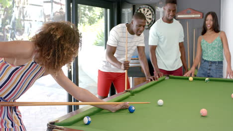 Young-African-American-men-and-biracial-women-enjoy-a-game-of-pool