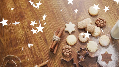 Animation-of-stars-falling-over-christmas-cookies-on-table