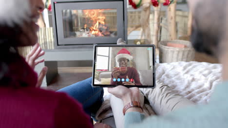 Happy-diverse-couple-and-male-friend-having-christmas-tablet-video-call,-slow-motion
