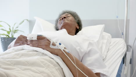 African-american-senior-female-patient-sleeping-in-bed-in-hospital-room,-slow-motion