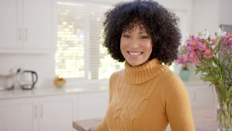 Portrait-of-happy-african-american-woman-with-curly-hair-at-home,-slow-motion