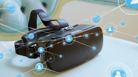 Animation-of-network-of-connections-with-icons-over-vr-headset-on-table