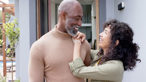 Portrait-of-happy-biracial-couple-embracing-at-new-house,-slow-motion
