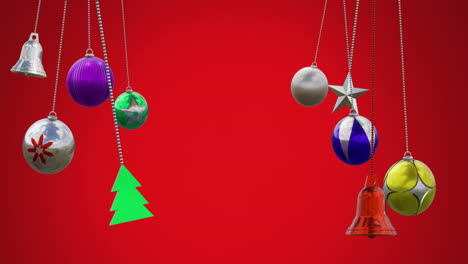 Animation-of-tree,-bell,-star-and-baubles-swinging-against-red-background