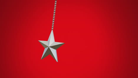 Animation-of-hanging-star-swinging-against-red-background