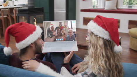 Happy-diverse-couple-and-friends-having-christmas-laptop-video-call,-slow-motion
