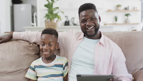 African-American-father-and-son-smile-in-a-home-setting