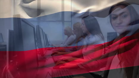 Animation-of-flag-of-russia-over-happy-caucasian-female-colleagues-working-at-computers