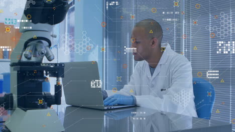 Animation-of-white-pixels-of-processing-data-over-biracial-male-scientist-using-laptop-in-laboratory