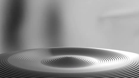 Animation-of-grey-ridged-circular-podium-rising-and-falling-on-blurred-background