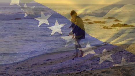 Animation-of-bosnian-flag-over-caucasian-mother-and-child-walking-on-beach