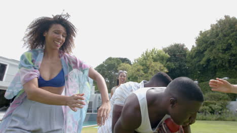 Young-African-American-man-and-biracial-women-enjoy-a-game-outdoors