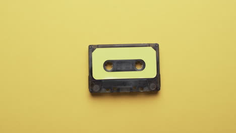 Video-of-retro-tape-with-yellow-label-with-copy-space-on-yellow-background
