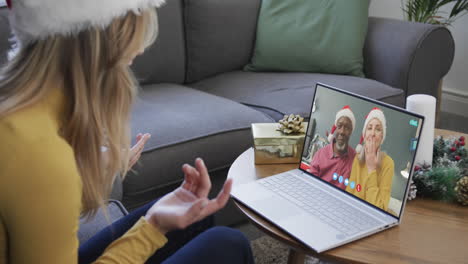 Happy-diverse-senior-couple-and-female-friend-having-christmas-laptop-video-call,-slow-motion