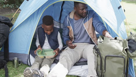 African-American-father-and-son-enjoy-camping-outdoors