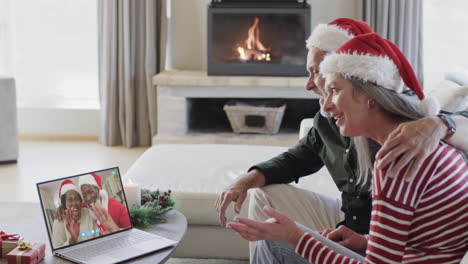 Happy-diverse-senior-couples-having-christmas-laptop-video-call,-slow-motion
