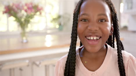 Portrait-of-happy-african-american-girl-with-long-hair-at-home,-slow-motion