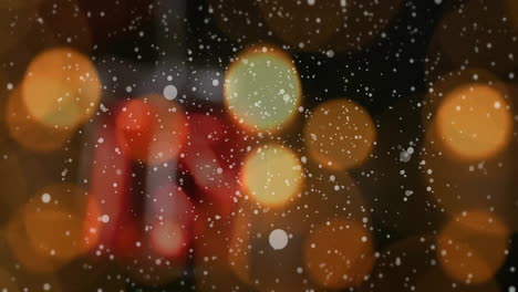 Animation-of-falling-snowflakes-over-candles-and-christmas-decoration