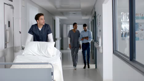 Diverse-male-and-female-doctors-walking-in-hospital-corridor,-slow-motion