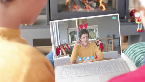Happy-caucasian-male-friends-having-christmas-laptop-video-call,-slow-motion