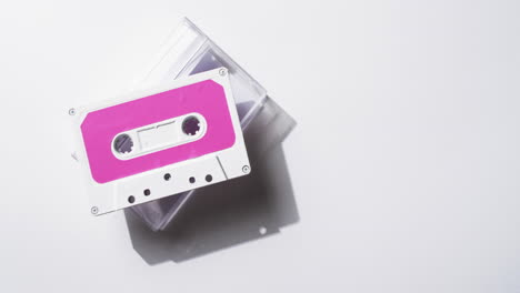 Video-of-retro-tape-with-pink-label-and-clear-box-with-copy-space-on-white-background