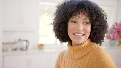 Happy-african-american-woman-with-curly-hair-at-home,-slow-motion