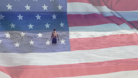Animation-of-flag-of-usa-over-caucasian-man-in-sea-in-summer
