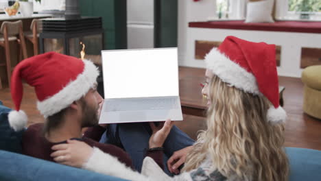 Happy-caucasian-couple-having-christmas-laptop-video-call-with-copy-space,-slow-motion