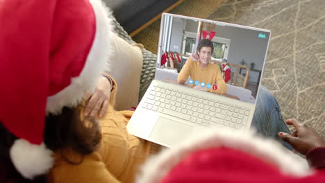 Happy-diverse-couple-and-male-friend-having-christmas-laptop-video-call,-slow-motion
