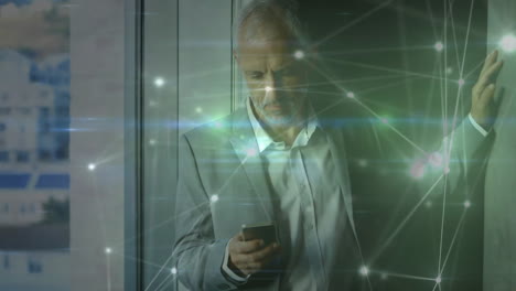 Animation-of-network-of-connections-caucasian-businessman-with-smartphone-in-office