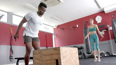 Fit-African-American-man-jumps-onto-a-box-at-the-gym