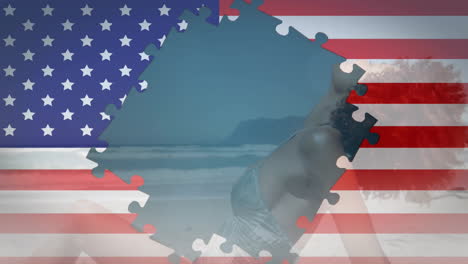 Animation-of-flag-of-usa-with-puzzle-pieces-over-african-american-woman-sunbathing-on-beach