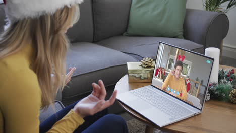 Happy-caucasian-couple-having-christmas-laptop-video-call,-slow-motion