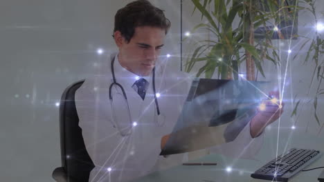 Animation-of-network-of-connections-over-caucasian-male-doctor-in-hospital
