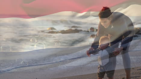 Animation-of-flag-of-netherlands-over-caucasian-mother-and-child-walking-on-sunny-beach