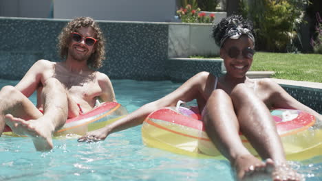 Young-couple-enjoys-a-sunny-day-in-the-pool