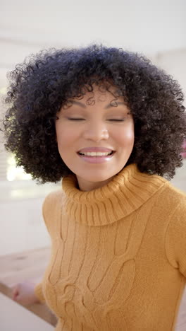 Vertical-video-of-happy-african-american-woman-at-home,-slow-motion