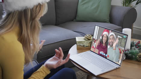 Happy-diverse-couple-and-female-friend-having-christmas-laptop-video-call,-slow-motion