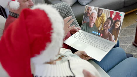 Happy-diverse-senior-couple-and-friends-having-christmas-laptop-video-call,-slow-motion